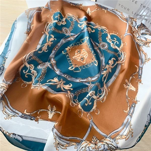 Détail du foulard en soie de style palais rétro avec motifs chaînes et satin