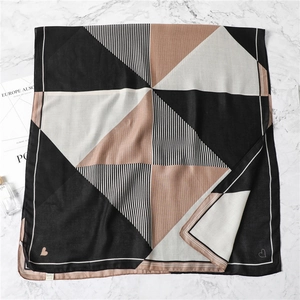 Detail of geometric stripe scarf showing heart patterns and soft cotton linen texture