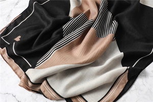 Detail of soft cotton-linen scarf showing geometric stripes and small heart pattern