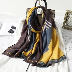 Women's minimalist geometric stripe scarf with heart prints in a chic lifestyle setting