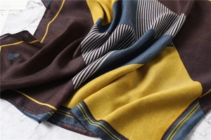 Detail view of cotton linen scarf showing soft geometric stripes and heart pattern texture