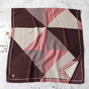 Geometric striped cotton linen scarf in burgundy and pink with embroidered heart logo