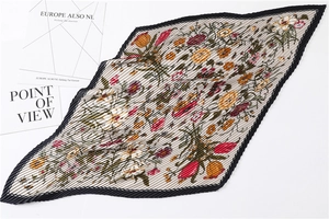 Detailed view of accordion pleated floral scarf with vintage tulip and daisy prints