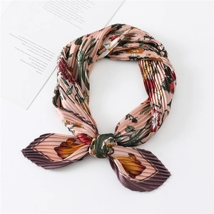 Detail of floral printed pleated silk scarf with pink and orange flower patterns