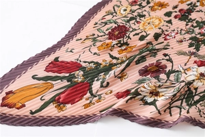 Detailed view of floral pleated satin scarf with vintage print and wavy edge finish