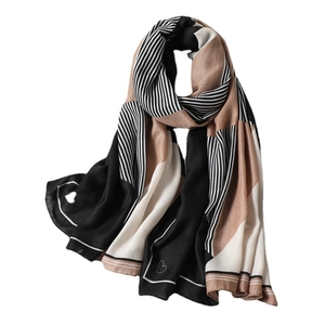 Minimalist geometric striped scarf with heart patterns in black, white and brown tones