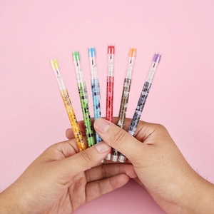 Close-up of 6 pixel art non-sharpening pencils with colorful mosaic designs and clear shells