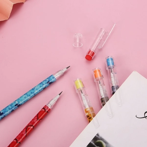 Flat lay of colorful mosaic multi-point stackable pencils on a pink background
