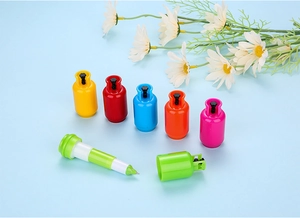 Macro shot of telescopic ballpoint pens shaped like colorful gas canisters in six bright colors