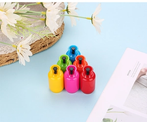 Detail of colorful gas canister shaped retractable pens arranged on blue background