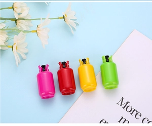 Close-up of colorful gas tank shaped retractable pens on a light blue background