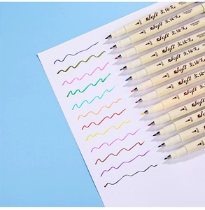 Macro shot of colorful brush sign pens with soft tips and wavy ink strokes on paper