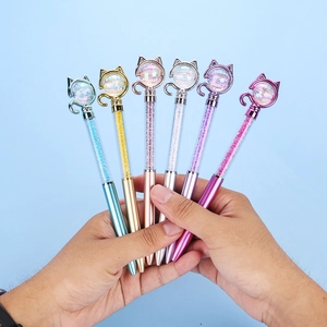 Detail of 6 colorful cat-themed ballpoint pens with diamond heads and crystal-filled bodies