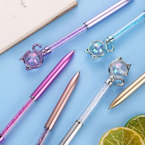 Detail of creative cat-themed crystal ballpoint pens with shimmering glitter filling