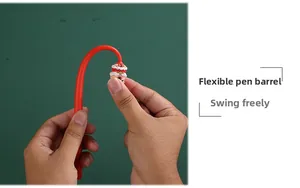 Detail of flexible red pen body being bent by hand with cartoon lion topper