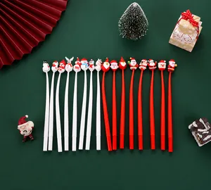 Flat lay of Christmas cartoon gel pens with silicone Santa and reindeer toppers