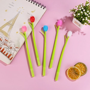 Flat lay of five colorful tulip-shaped gel pens with green leaf stems on a pink desk