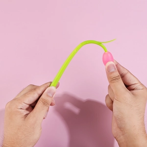 Flexible tulip flower pen made of soft silicone being bent to show durability