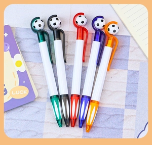 Close-up of five colorful rotating football pens with black and white soccer clips