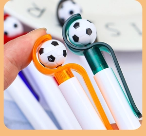 Macro view of a creative football pen with a rotating soccer ball on top of the clip