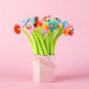 Detail of floral cartoon gel pens with silicone flowers in a marble textured holder