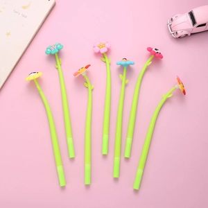Macro shot of colorful flower-shaped gel pens with green leaf stems on pink background