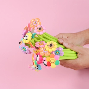 Close-up of colorful flower shaker pens with cartoon smile faces and green stems