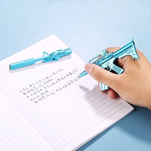 Creative blue metal gun-shaped gel pen shown writing on a notebook for school gifts