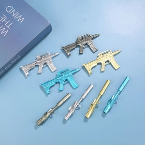 Detailed set of 7 gun-shaped gel pens in matte black and metallic finishes on blue paper
