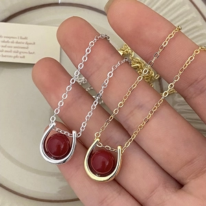 Minimalist horseshoe pendant necklaces in gold and silver with red agate stones for couples