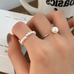 Set of freshwater pearl rings featuring a silver open band and beaded pearl circle