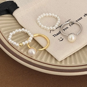Minimalist freshwater pearl ring set with gold and silver bands on ceramic tray
