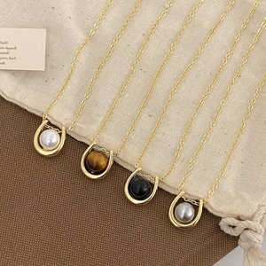 French minimalist horseshoe necklaces with natural stones and pearls on golden chains