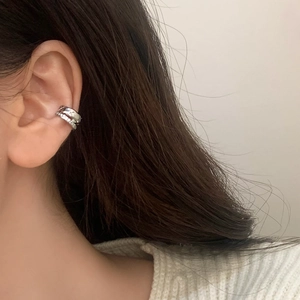Macro shot of silver double-layered ear cuff featuring micro-pave cubic zirconia stones