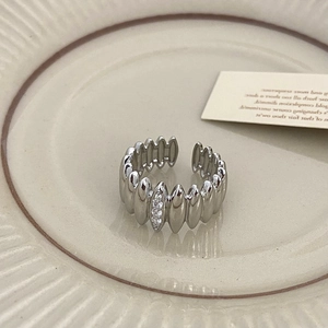 Close-up of silver adjustable ring with vertical wave texture and three vertical zircons