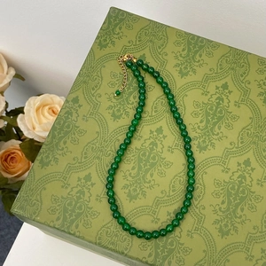 Detail of green chalcedony beaded necklace with gold lobster clasp on elegant box