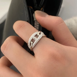 Detailed view of silver pig nose ring featuring micro-pave cubic zirconia on hand