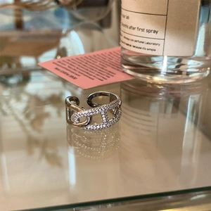 Close-up of adjustable silver anchor link ring featuring sparkling pave white zircons