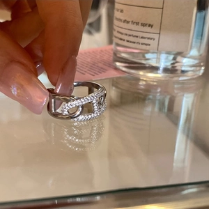 Detailed view of silver pig nose ring with pavé cubic zirconia and polished finish