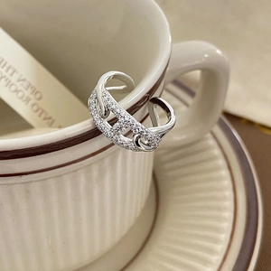 Detail shot of a silver adjustable pig nose ring with sparkling pavé zircons on a cup