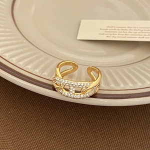 Macro shot of gold pig nose open ring featuring white pavé zircons and a double-layer design