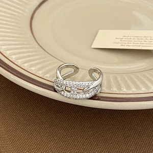 Macro detail of silver adjustable ring with pig nose link design and sparkling zircons