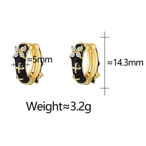 Detail of black enamel huggie earrings with star motifs and dimensions 5x14.3mm