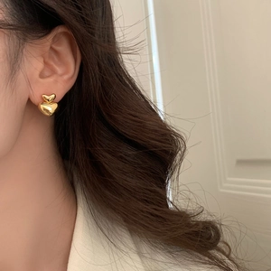 Minimalist double layer gold heart drop earrings shown on model for daily wear