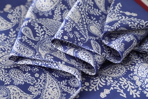 Detailed view of dark blue paisley print fabric with a luxurious silky twill texture