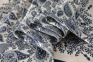 Detailed view of paisley silk scarf showing soft drape and ivory blue floral print