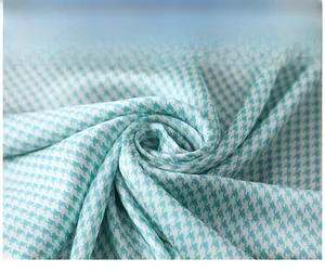Close-up of blue and white houndstooth silk-like scarf with elegant spiral fold texture