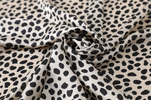 Vue détaillée d'un foulard en soie à imprimé léopard avec élégant drapé en spirale