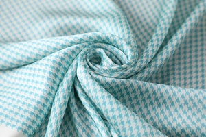 Macro shot of blue and white houndstooth silk scarf showing soft texture and glossy finish