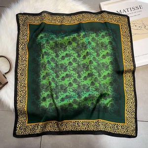 Green silk square scarf with floral pattern and yellow leopard print border detail